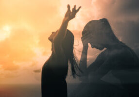 Sad woman becomes happy and free. People letting go of fears, sadness, grief and pain concept.